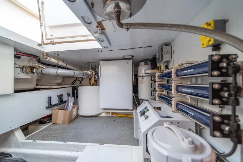 Slide: The Image of Engine room of 2005 Ocean Alexander 64 Motoryacht, featuring mechanical equipment and storage. - 55