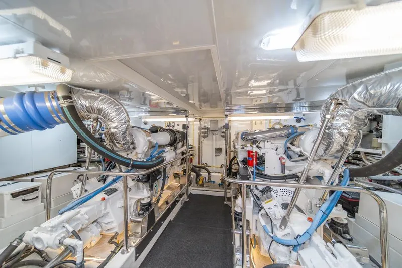 Slide: The Image of Engine room of 2005 Ocean Alexander 64 Motoryacht, featuring dual engines and modern equipment. - 56