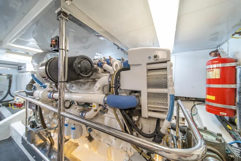 Slide: The Image of Engine room of 2005 Ocean Alexander 64 Motoryacht, featuring mechanical components and fire extinguisher. - 59