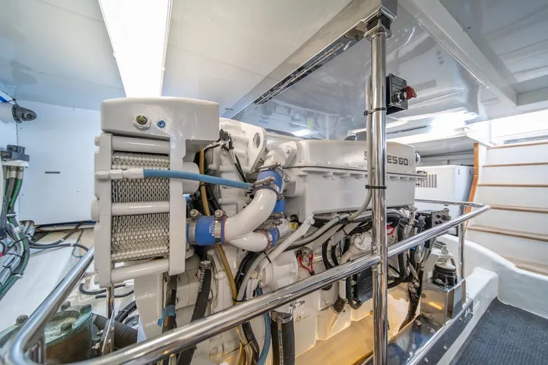 Slide: The Image of Engine room of 2005 Ocean Alexander 64 Motoryacht, showcasing mechanical components and piping. - 60