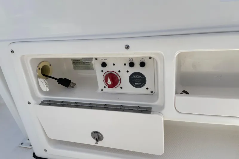 Slide: The Image of Control panel of a 2015 Robalo 246 Cayman boat, featuring switches and outlets. - 11