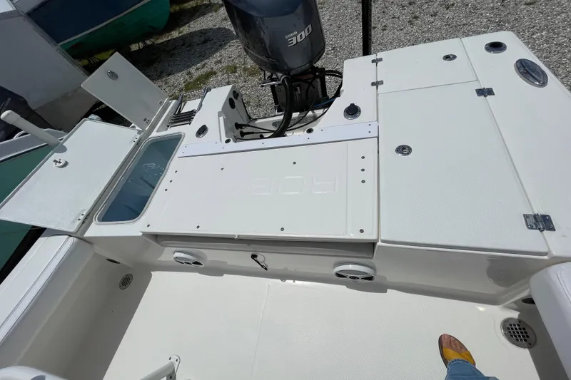 Slide: The Image of 2015 Robalo 246 Cayman boat deck with Yamaha 300 engine, open storage compartments. - 18