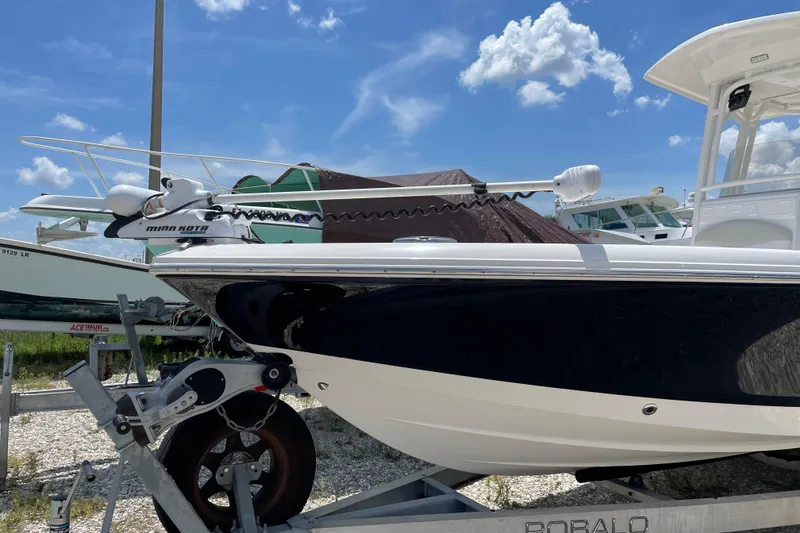 Slide: The Image of 2015 Robalo 246 Cayman boat on trailer under blue sky. - 3