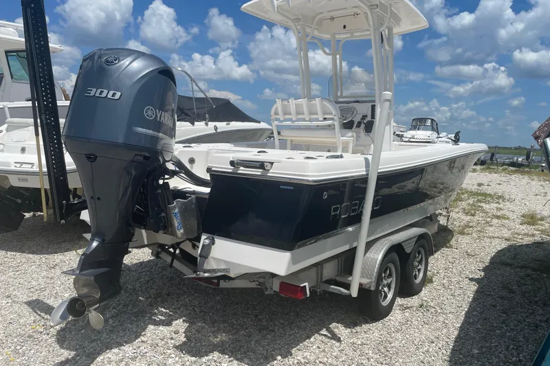 Slide: The Image of 2015 Robalo 246 Cayman boat with Yamaha 300 engine on trailer, parked outdoors. - 4