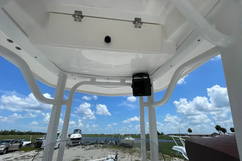 Slide: The Image of 2015 Robalo 246 Cayman boat interior with electronics, under a clear blue sky. - 7
