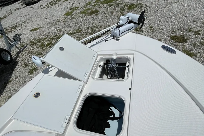 Slide: The Image of 2015 Robalo 246 Cayman boat deck with storage compartments and trolling motor. - 9