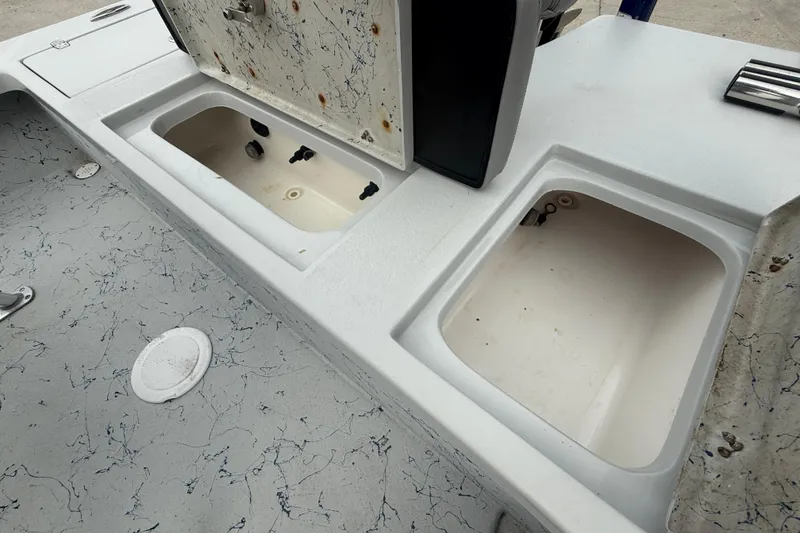 Slide: The Image of Open storage compartment on 2017 Blazer Bay 2420 boat with marbled surface. - 14