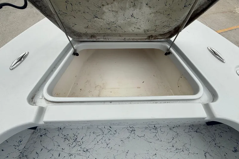 Slide: The Image of 2017 Blazer Bay 2420 boat interior with open storage compartments and textured flooring. - 15