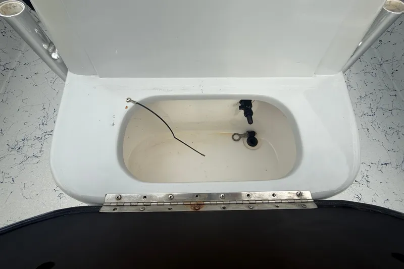 Slide: The Image of 2017 Blazer Bay 2420 boat livewell with open lid and plumbing fixtures. - 17