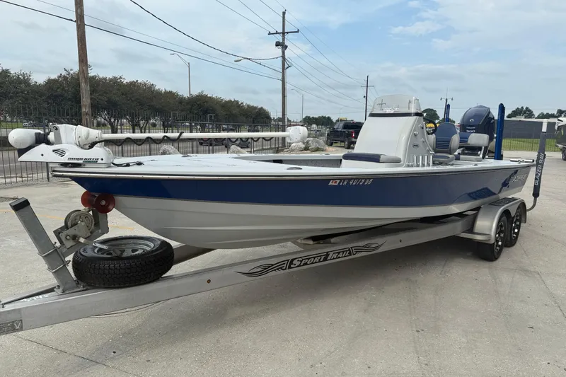 Slide: The Image of 2017 Blazer Bay 2420 boat on trailer, front view, parked outdoors. - 3
