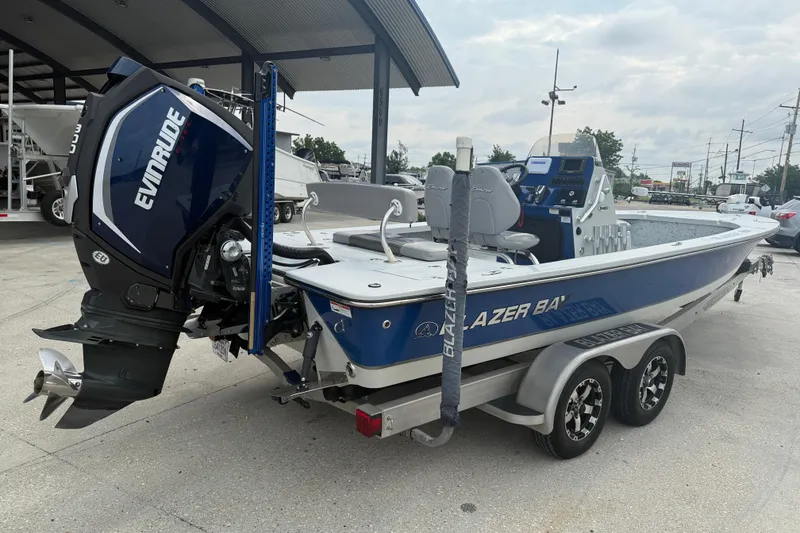 Slide: The Image of 2017 Blazer Bay 2420 boat with Evinrude 300 engine, parked in a lot. - 6