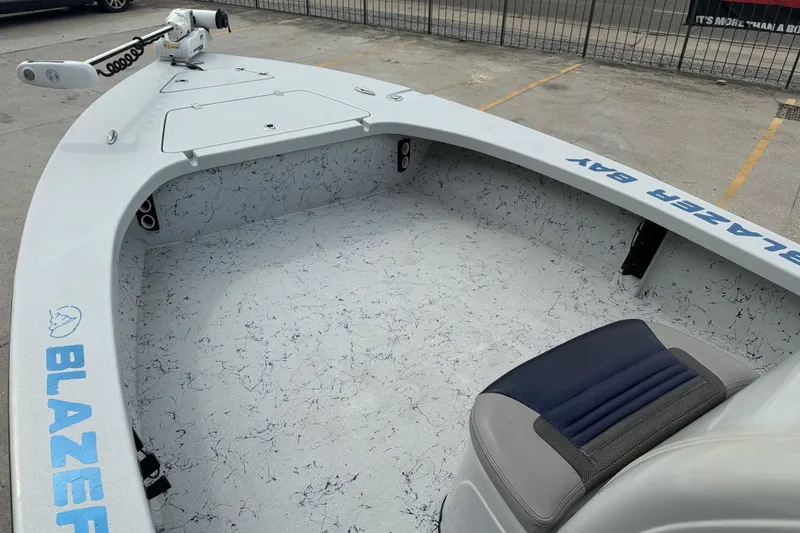 Slide: The Image of 2017 Blazer Bay 2420 boat interior with dual seats and navigation console. - 8
