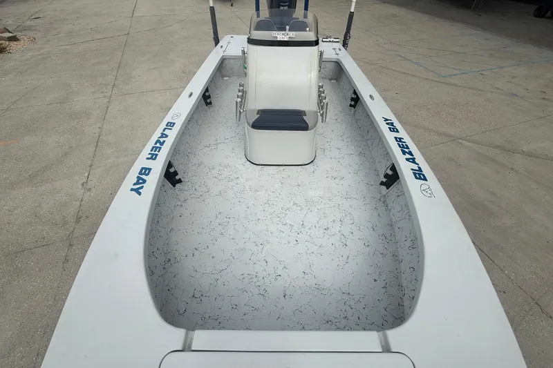 Slide: The Image of 2017 Blazer Bay 2420 boat interior with trolling motor and seating. - 9