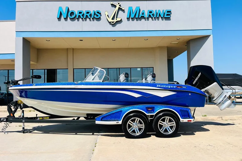 Slide: The Image of 2024 Ranger 620FS Pro boat in blue, parked outside Norris Marine dealership. - 1