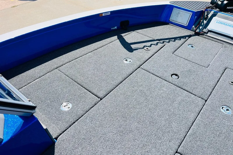 Slide: The Image of 2024 Ranger 620FS Pro boat deck with carpeted storage compartments and fishing equipment. - 17