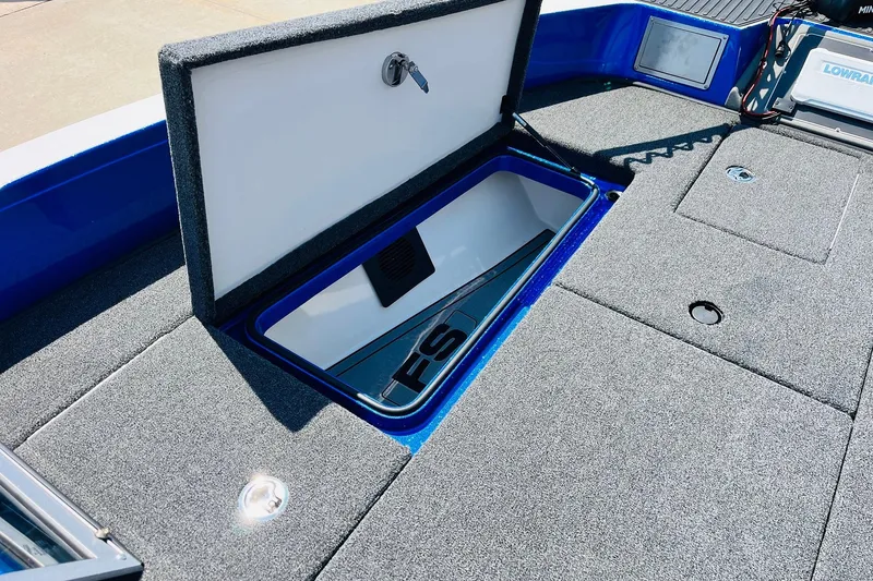 Slide: The Image of 2024 Ranger 620FS Pro boat storage compartment with open lid, showcasing interior design. - 20