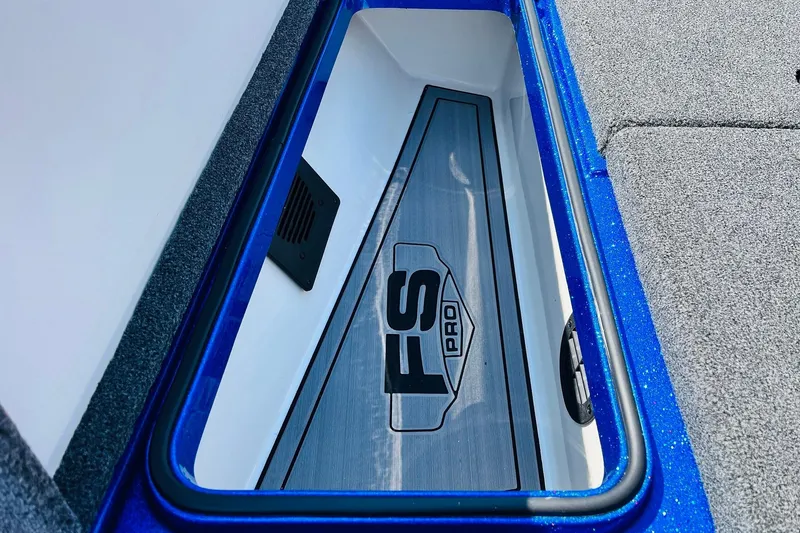 Slide: The Image of 2024 Ranger 620FS Pro boat storage compartment with blue trim and FS Pro logo. - 21