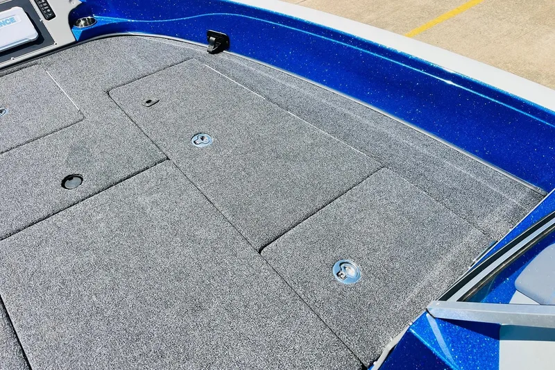 Slide: The Image of 2024 Ranger 620FS Pro boat deck with gray carpet and blue trim. - 24