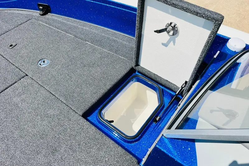 Slide: The Image of 2024 Ranger 620FS Pro boat with open storage compartment, blue and gray interior. - 25