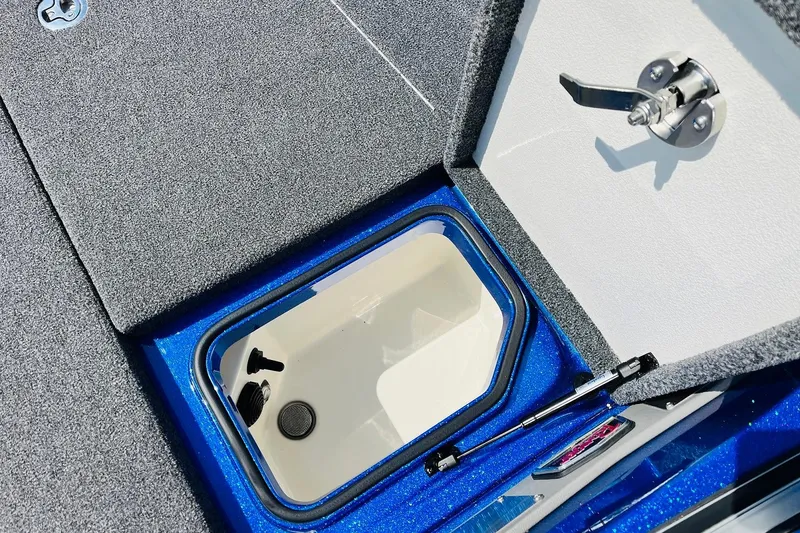 Slide: The Image of 2024 Ranger 620FS Pro boat storage compartment with open lid and latch. - 26