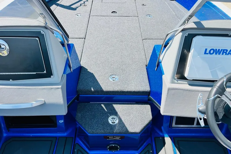 Slide: The Image of 2024 Ranger 620FS Pro boat interior with Lowrance electronics and gray carpeted deck. - 29