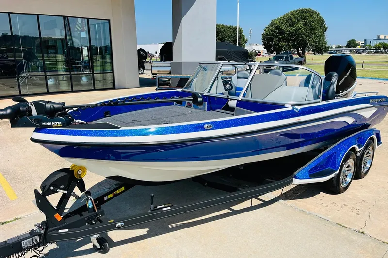 Slide: The Image of 2024 Ranger 620FS Pro boat in blue, parked on a trailer outside a building. - 3
