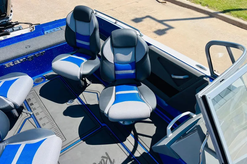 Slide: The Image of 2024 Ranger 620FS Pro boat interior with blue and gray seating, showcasing modern design. - 36
