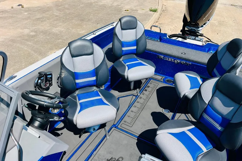 Slide: The Image of 2024 Ranger 620FS Pro boat interior with blue and gray seating, steering wheel, and deck. - 37
