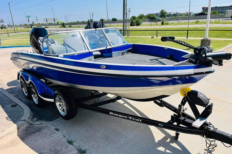 Slide: The Image of 2024 Ranger 620FS Pro boat in blue on a trailer, parked outdoors. - 4
