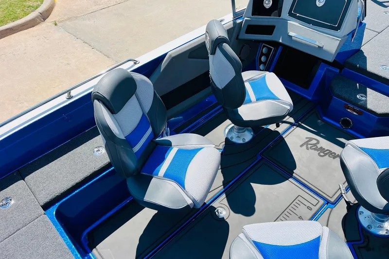 Slide: The Image of 2024 Ranger 620FS Pro boat interior with blue and gray seating and console. - 40