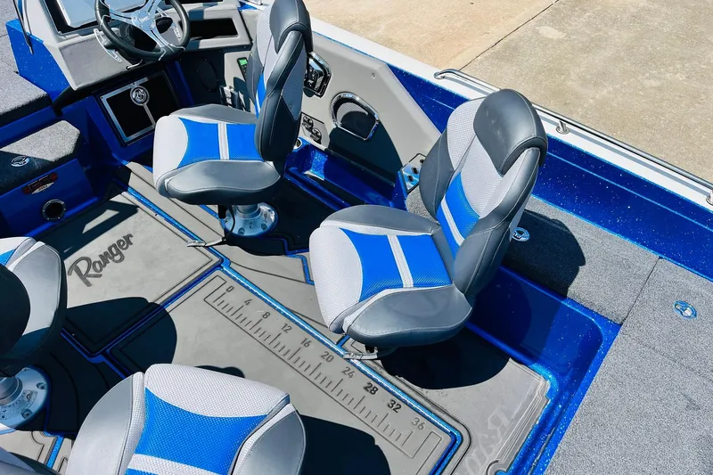 Slide: The Image of 2024 Ranger 620FS Pro boat interior with blue and gray seating and measuring mat. - 41