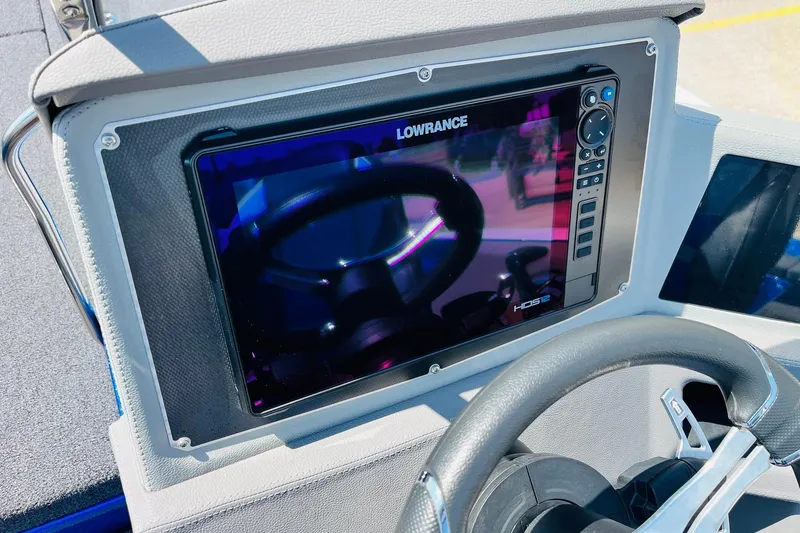 Slide: The Image of 2024 Ranger 620FS Pro boat dashboard with Lowrance HDS7 display and steering wheel. - 48