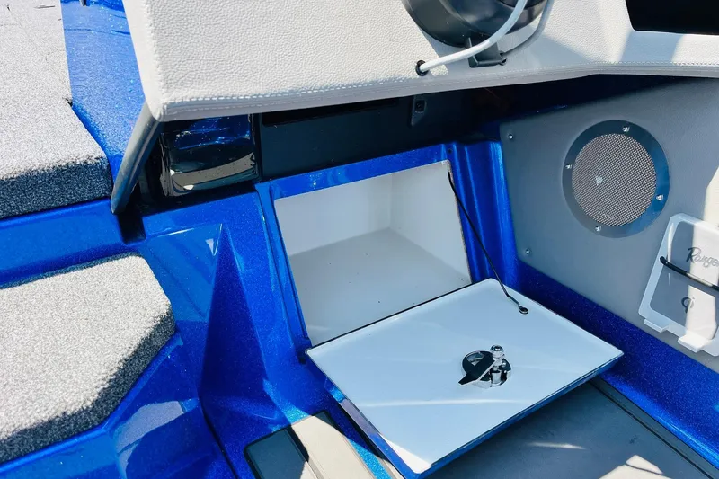 Slide: The Image of 2024 Ranger 620FS Pro boat interior storage compartment with blue and gray design. - 51