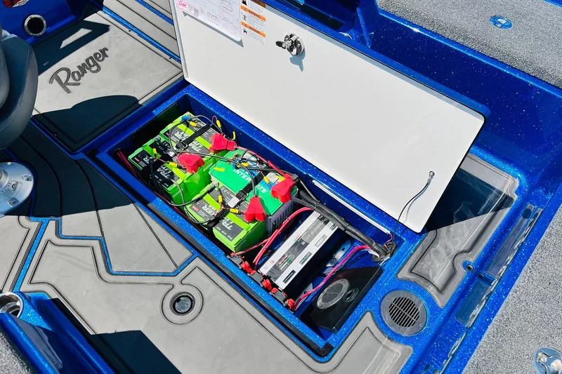 Slide: The Image of 2024 Ranger 620FS Pro boat battery compartment with multiple batteries and wiring. - 55