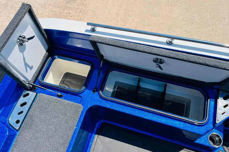 Slide: The Image of 2024 Ranger 620FS Pro boat storage compartments with open lids, showcasing interior design. - 61