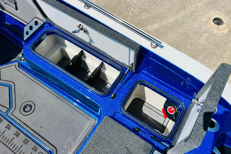Slide: The Image of 2024 Ranger 620FS Pro boat storage compartments with blue interior detailing. - 64
