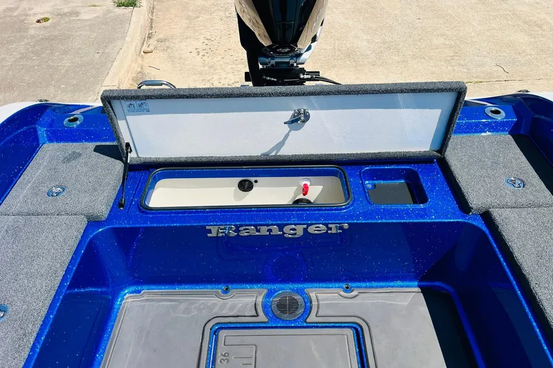 Slide: The Image of 2024 Ranger 620FS Pro boat interior with open storage compartment, blue finish. - 65