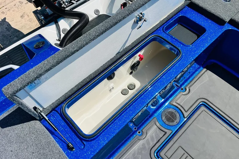 Slide: The Image of 2024 Ranger 620FS Pro boat interior with open storage compartment and blue accents. - 66