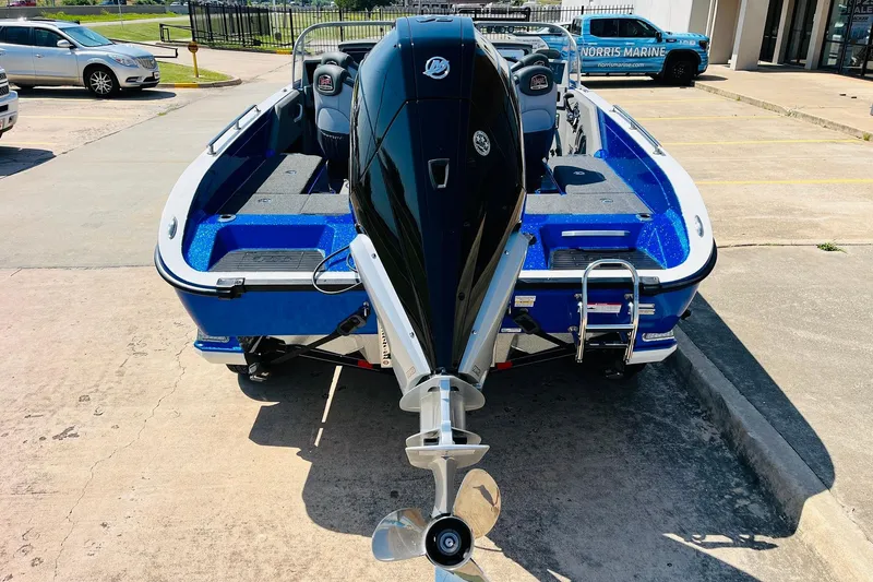 Slide: The Image of 2024 Ranger 620FS Pro boat with powerful outboard motor, parked outdoors. - 7
