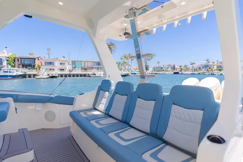 Slide: The Image of Luxurious seating on 2023 Scout 530 LXF yacht, docked in a scenic marina. - 11