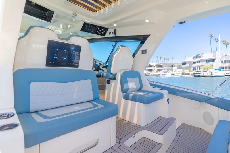 Slide: The Image of Interior of 2023 Scout 530 LXF yacht with blue seating and digital display. - 12