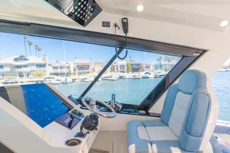Slide: The Image of 2023 Scout 530 LXF yacht cockpit with modern controls and waterfront view. - 14