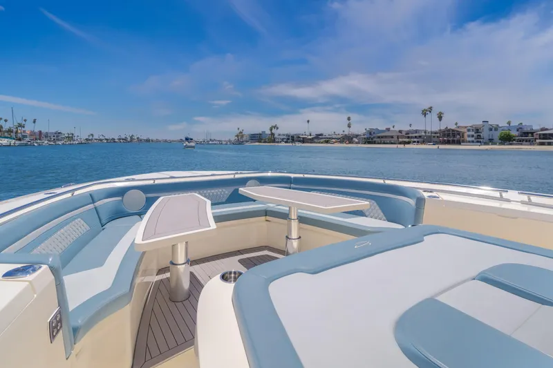 Slide: The Image of 2023 Scout 530 LXF luxury boat interior with waterfront view, featuring elegant seating and tables. - 16