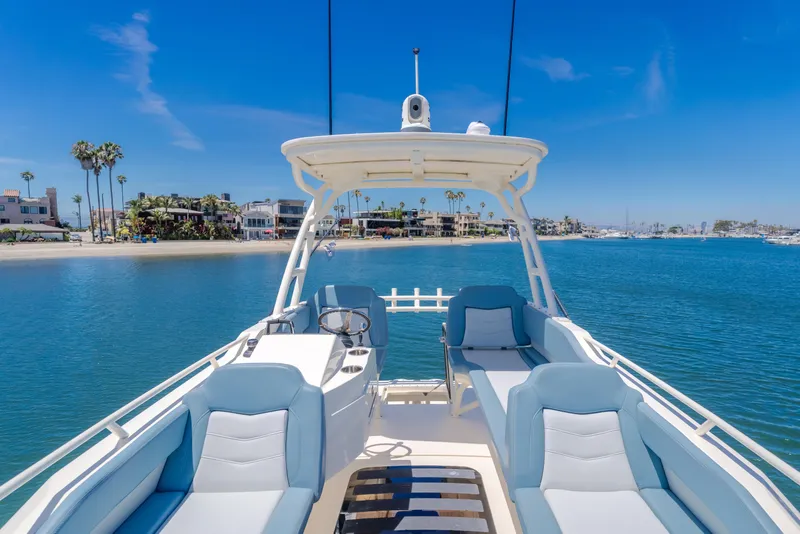 Slide: The Image of 2023 Scout 530 LXF luxury boat interior with ocean view and coastal backdrop. - 21