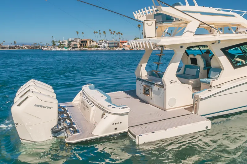 Slide: The Image of 2023 Scout 530 LXF luxury boat with Mercury engines on a sunny day. - 22