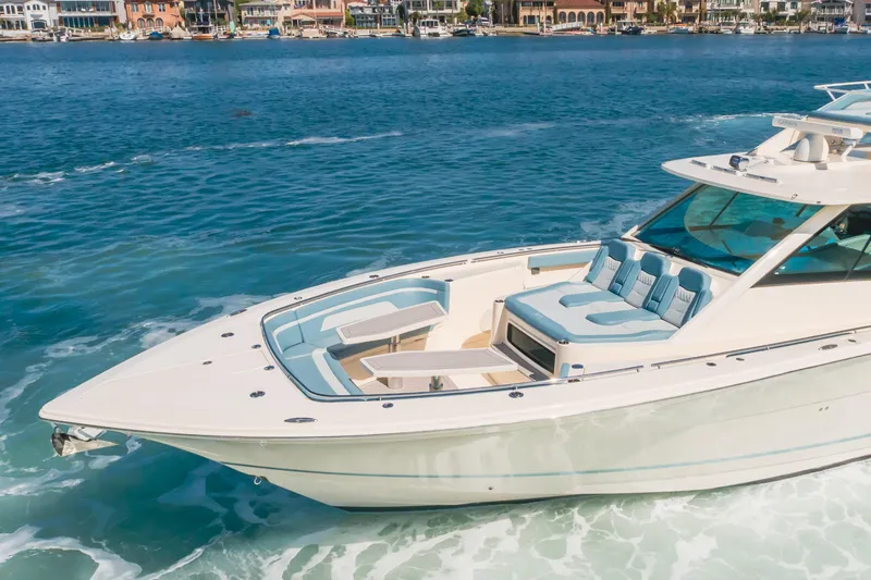 Slide: The Image of 2023 Scout 530 LXF luxury boat cruising on clear blue water. - 24