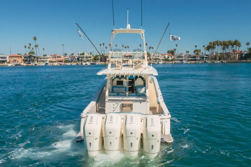 Slide: The Image of 2023 Scout 530 LXF luxury boat cruising in a scenic waterfront setting. - 31