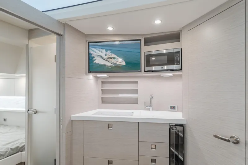 Slide: The Image of Luxurious interior of 2023 Scout 530 LXF yacht with modern kitchenette and TV. - 4