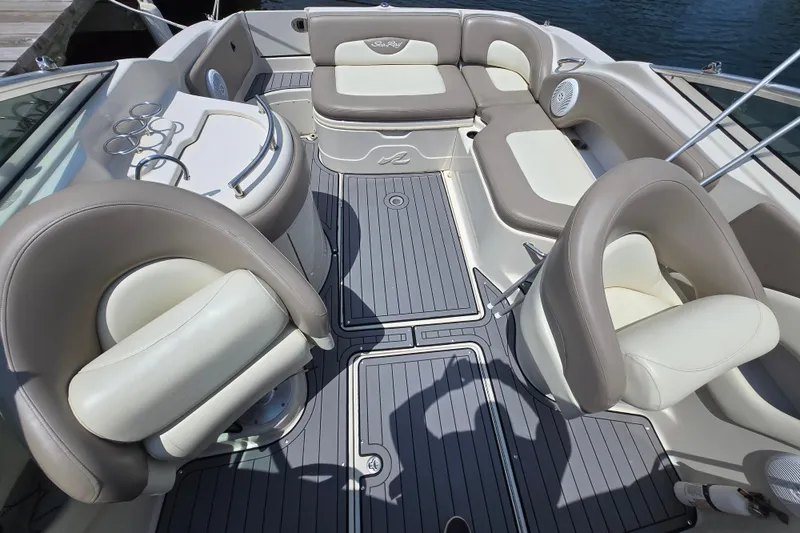 Slide: The Image of 2006 Sea Ray 270 Sundeck interior with cushioned seating and sleek design. - 3