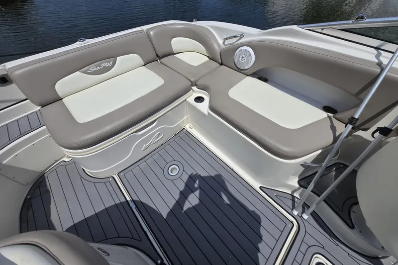 Slide: The Image of 2006 Sea Ray 270 Sundeck interior with cushioned seating and sleek design. - 4